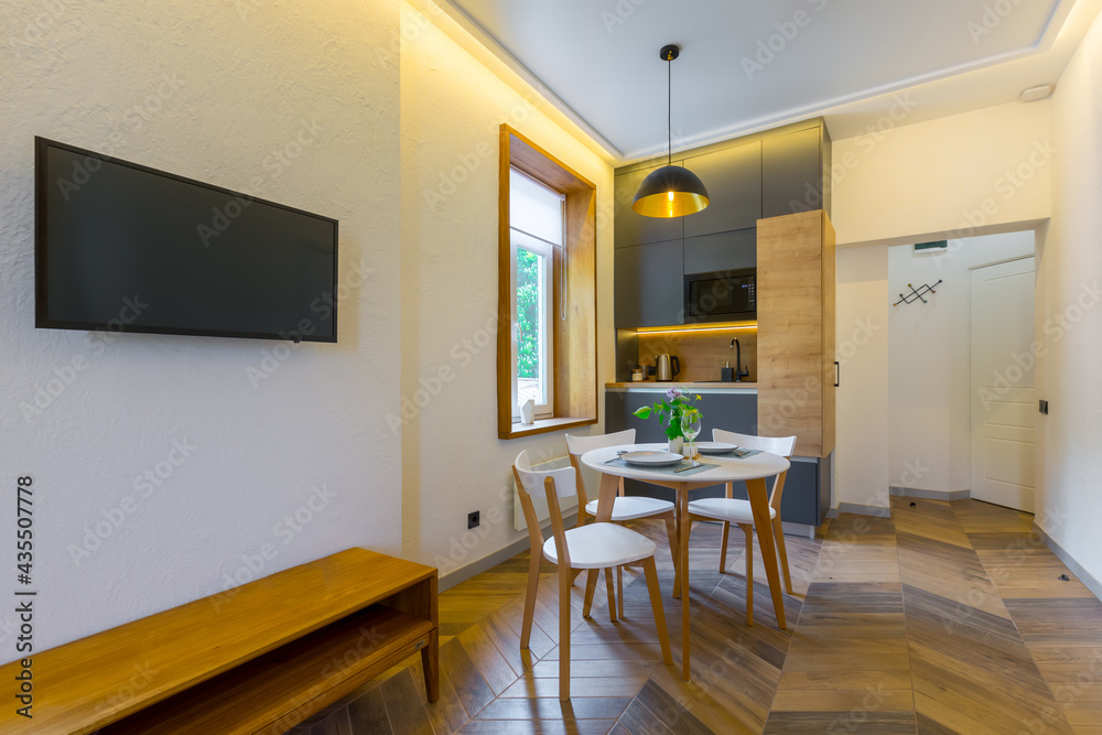 Interior photography, loft style, small apartment with warm light and dark kitchen Interior photography, loft style, small apartment with warm light and dark kitchen