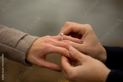 close up of a man presenting his girlfriend with an engagement ring