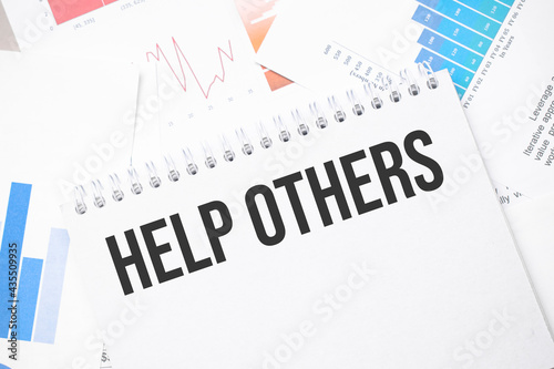 help others text on paper on the chart background with pen