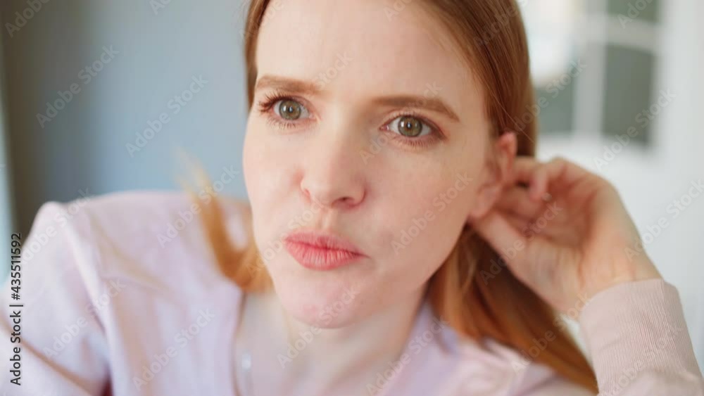 Zoom in of young woman smiling while talking to male friend, husband or therapist with laptop sitting on sofa Zoom in of young woman smiling while talking to male friend, husband or therapist with laptop sitting on sofa