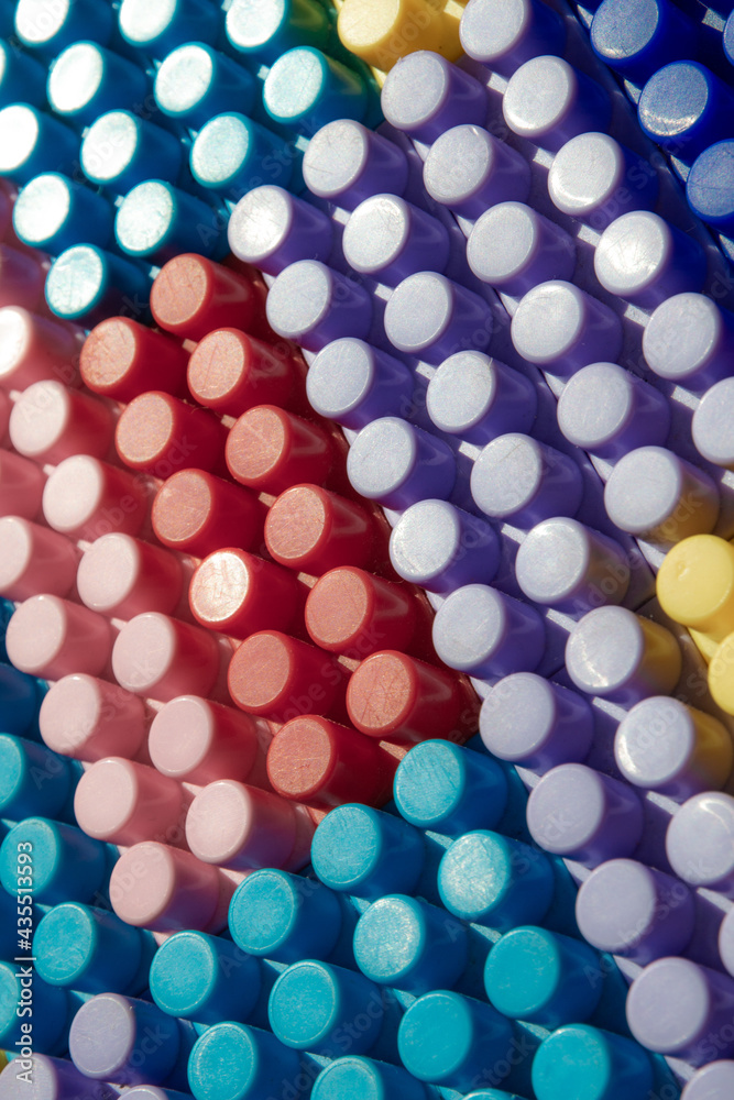 children's play background: the plane of plastic multi-colored bricks, blur, selective focus