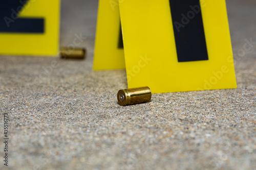 Gun shell casing at crime scene. Gun violence, mass shooting and homicide investigation concept. photo
