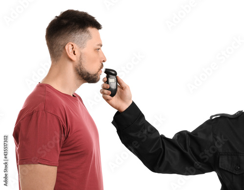 Fotografie Police inspector conducting alcohol breathe testing, man blowing into breathalyz
