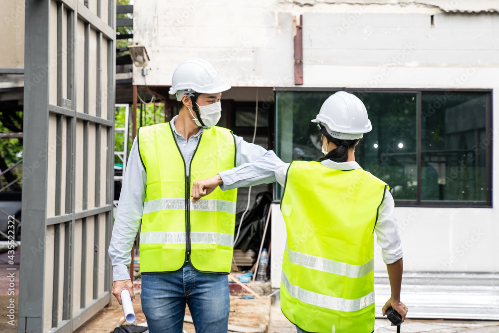 Asian architect or engineer team greeting each other by elbow bump. Asian architect or engineer team greeting each other by elbow bump.