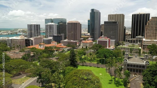 Cinematic 4K aerial drone shot of the Iolani Palace downtown Honolulu, popular Polynesian, Pacific Island tourist destination on Oahu island in Hawaii known for its surfing and beaches photo