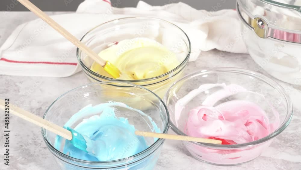 Step by step. Mixing in food coloring into the meringue to bake unicorn meringue pops cookies. Step by step. Mixing in food coloring into the meringue to bake unicorn meringue pops cookies.