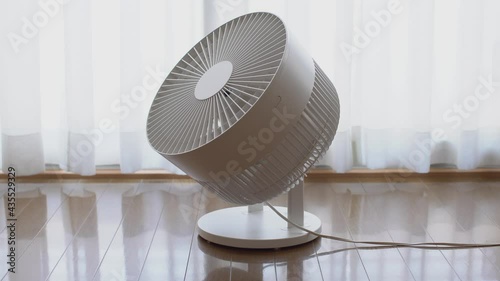 Air circulator by the window photo