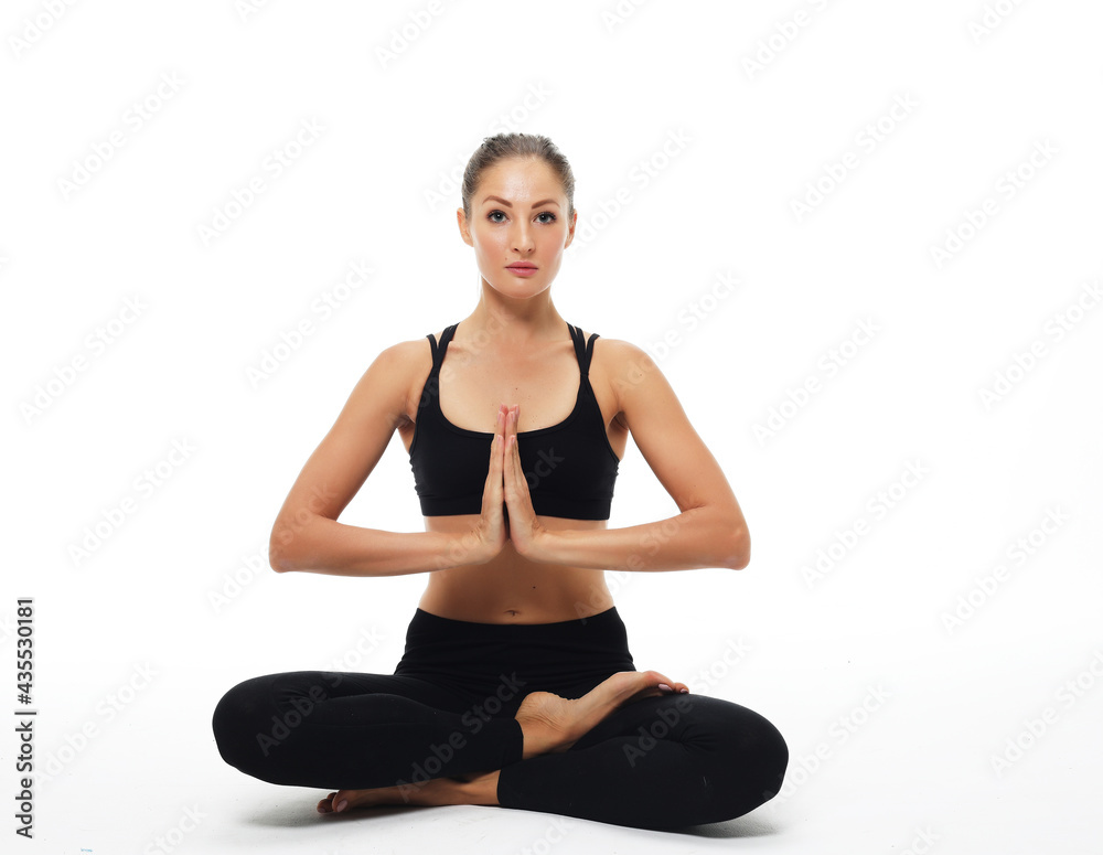 Sporty young woman doing yoga practice isolated on white background Sporty young woman doing yoga practice isolated on white background