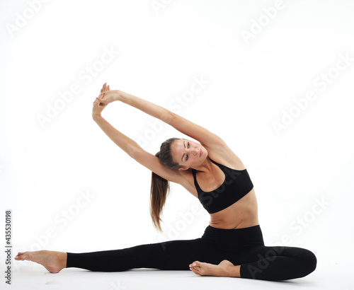 Fototapeta Naklejka Na Ścianę i Meble -  Healthy female isolated on white practicing yoga. A beginner yoga woman is in basic yoga pose.