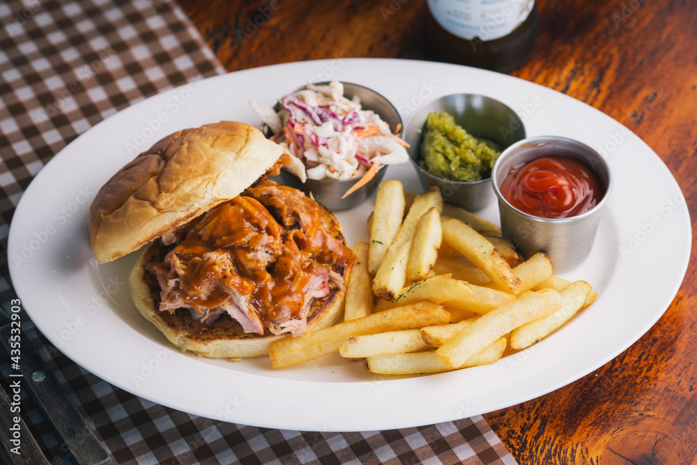 pulled pork sandwich with coleslaw and French fries