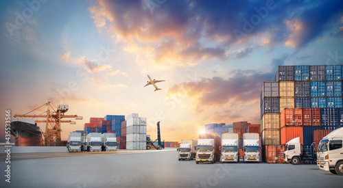 Container truck in ship port for business Logistics and transportation of Container Cargo ship and Cargo plane with working crane bridge in shipyard, logistic import export concept