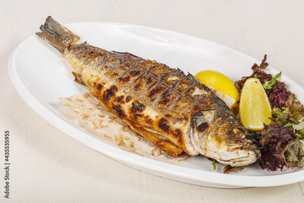 Grilled seabass fish served lemon Grilled seabass fish served lemon