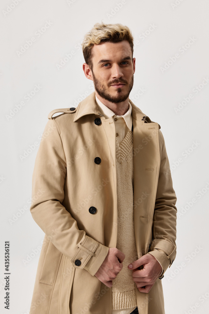 portrait of a blonde in a beige coat and a light background beautiful face trend of the season spring portrait of a blonde in a beige coat and a light background beautiful face trend of the season spring