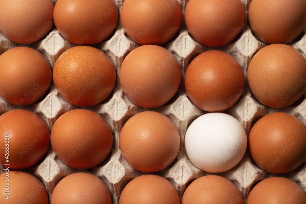 Chicken brown and white fresh raw eggs in a carton container. Ingredients for cooking. Concept for healthy eating. Selective focus. Chicken brown and white fresh raw eggs in a carton container. Ingredients for cooking. Concept for healthy eating. Selective focus.