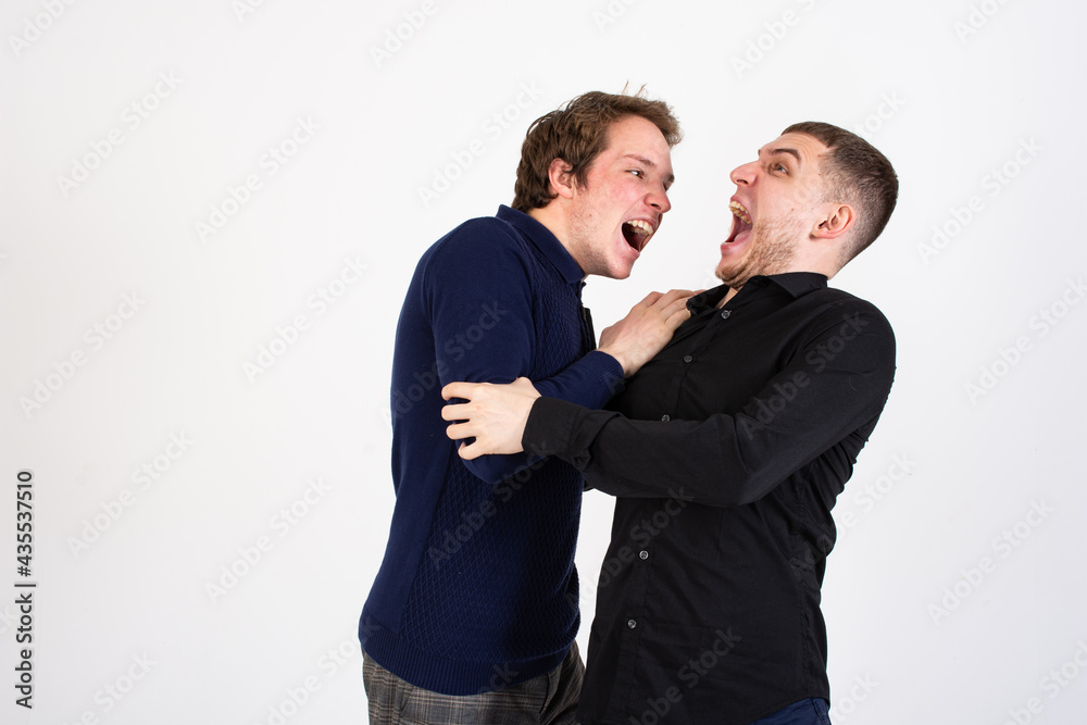 Young attractive couple. Two handsome men in the studio. Young attractive couple. Two handsome men in the studio.