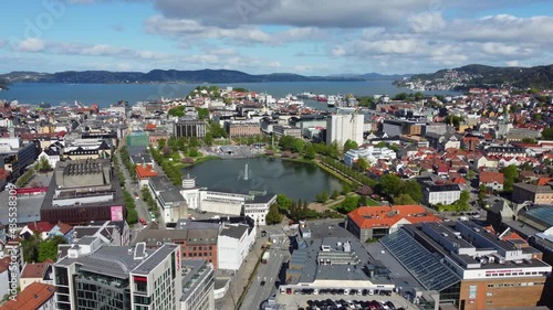 Forward moving aerial Bergen city centre with water fountain in park and seafront in the background - Norway photo