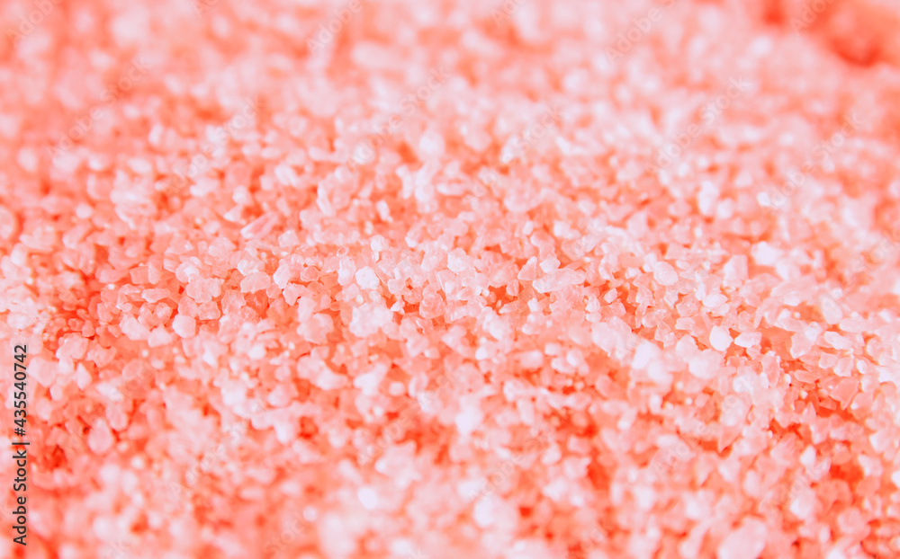 Pink sea salt close-up. The texture of salt crystals. The background is made of natural ingredients. Pink sea salt close-up. The texture of salt crystals. The background is made of natural ingredients.