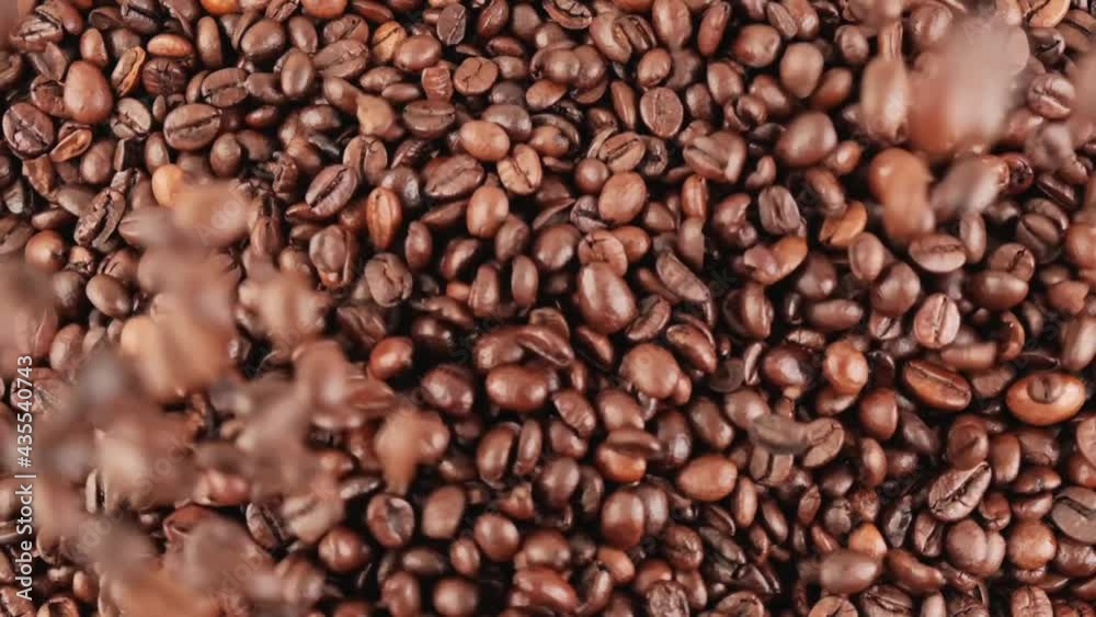 Close-up of black coffee beans falling from top to bottom. A lot of black roasted large grains. The concept of natural black coffee. Black background. Close-up of black coffee beans falling from top to bottom. A lot of black roasted large grains. The concept of natural black coffee. Black background.