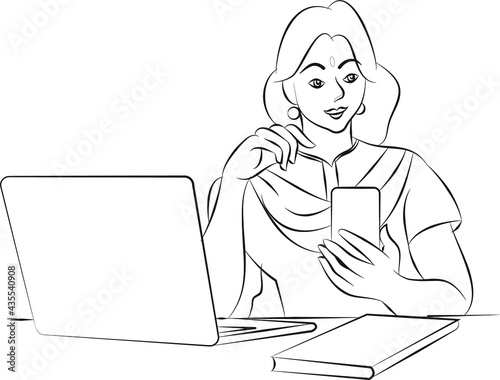 Indian woman using a mobile phone while working at home with a laptop.