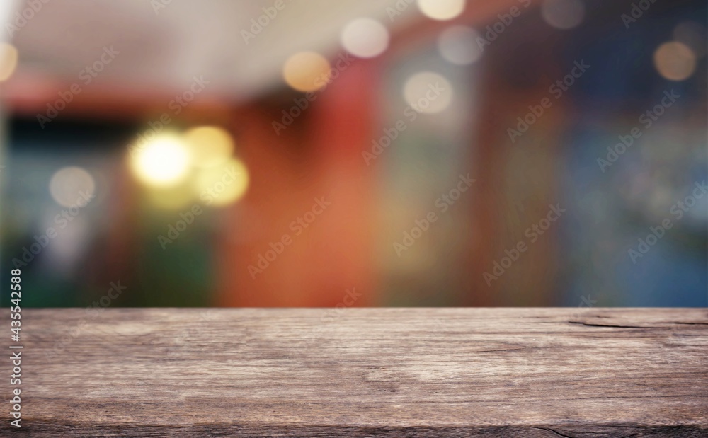 Empty wooden table in front of abstract blurred background of coffee shop . can be used for display or montage your products.Mock up for display of product