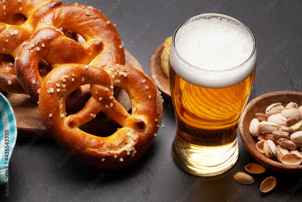 Lager beer, nuts, potato chips and fresh homemade pretzel