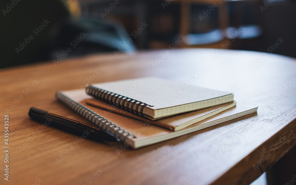 Fototapeta premium Closeup image of notebooks on wooden table