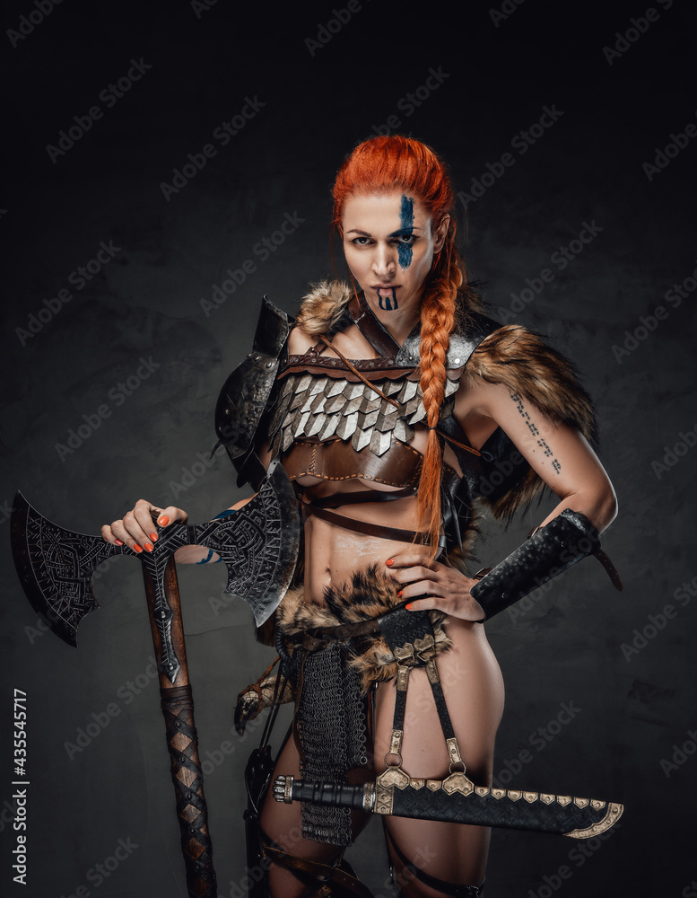 Furious woman warrior with muscular build and axe in dark background Furious woman warrior with muscular build and axe in dark background