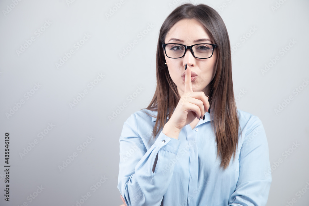 Portrait of beautiful woman with finger on lips Portrait of beautiful woman with finger on lips