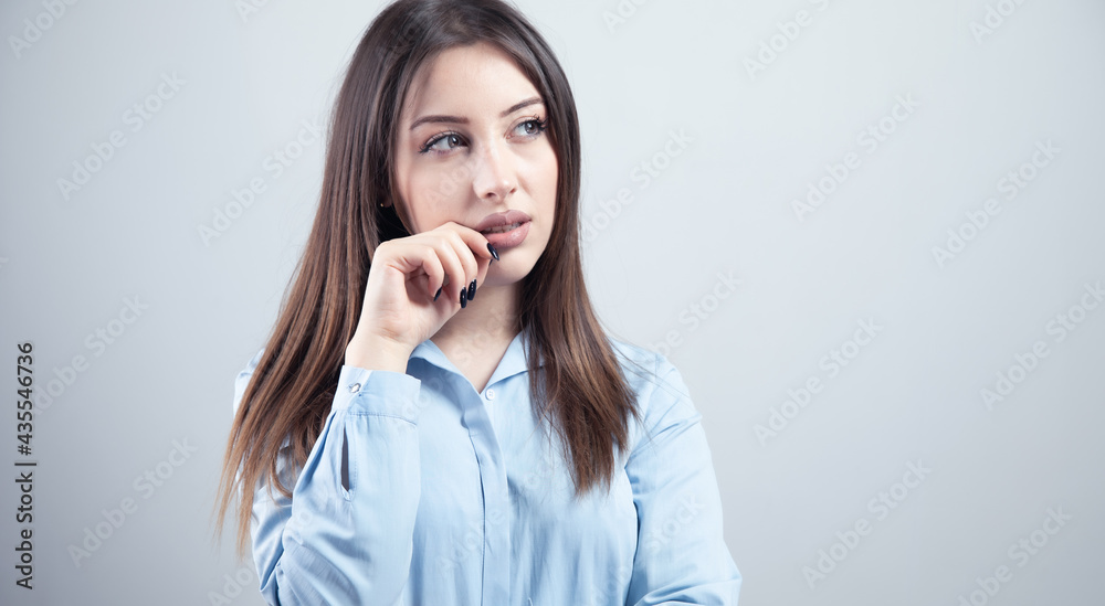 young woman thinking looks left young woman thinking looks left