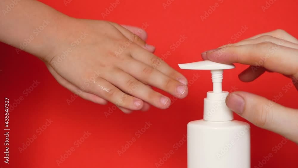 The theme of hygiene and washing of children's hands. Close-up of an adult's hands helping to clean the toddler's hands with an antiseptic and liquid soap. The child washes his hands. selective focus, The theme of hygiene and washing of children's hands. Close-up of an adult's hands helping to clean the toddler's hands with an antiseptic and liquid soap. The child washes his hands. selective focus,