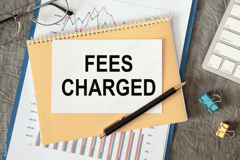 FEES CHARGED is written in a document on the office desk Stock Photo
