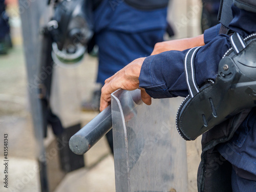 Riot police practice shields and baton