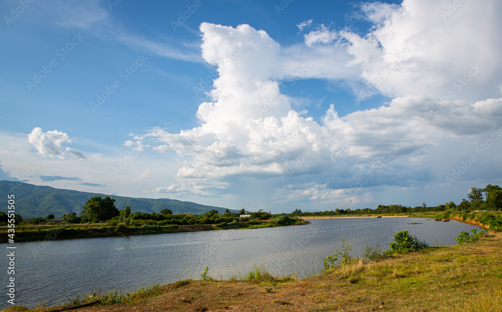 Summer landscape of a river and cloudy sky in Northern Thailand. 