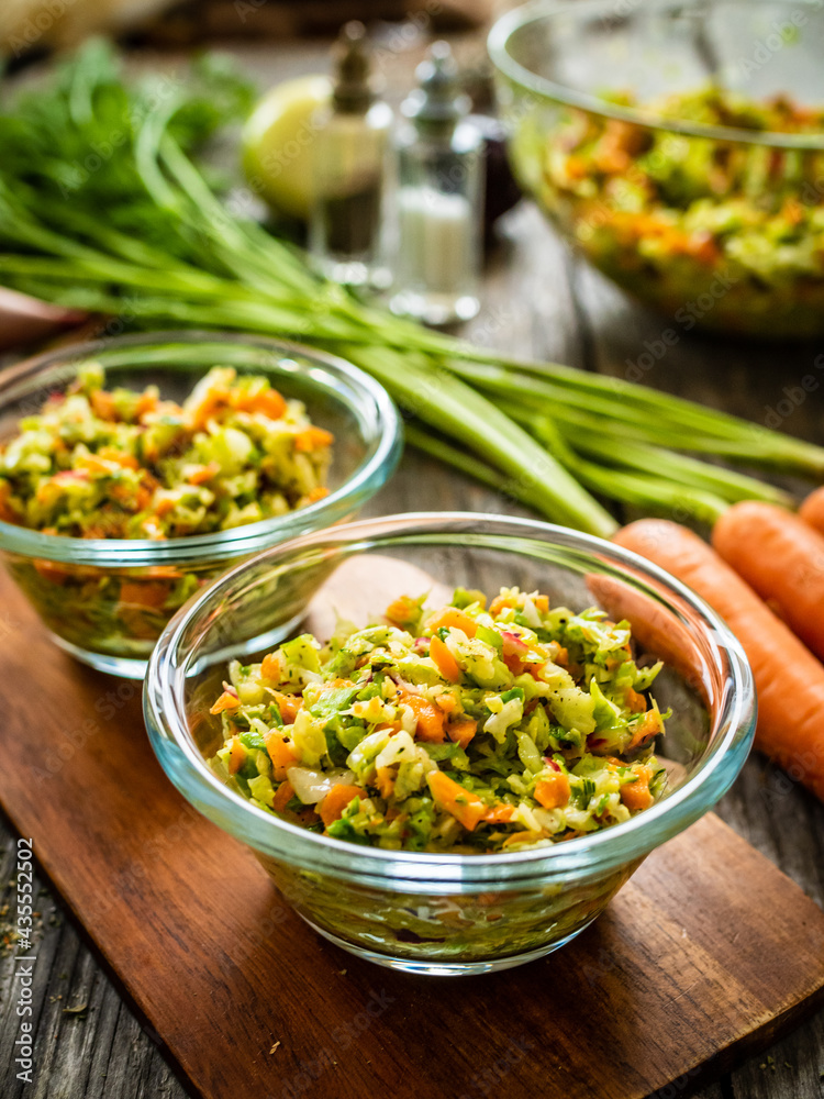 Fresh spring vegetable salad on wooden table Fresh spring vegetable salad on wooden table