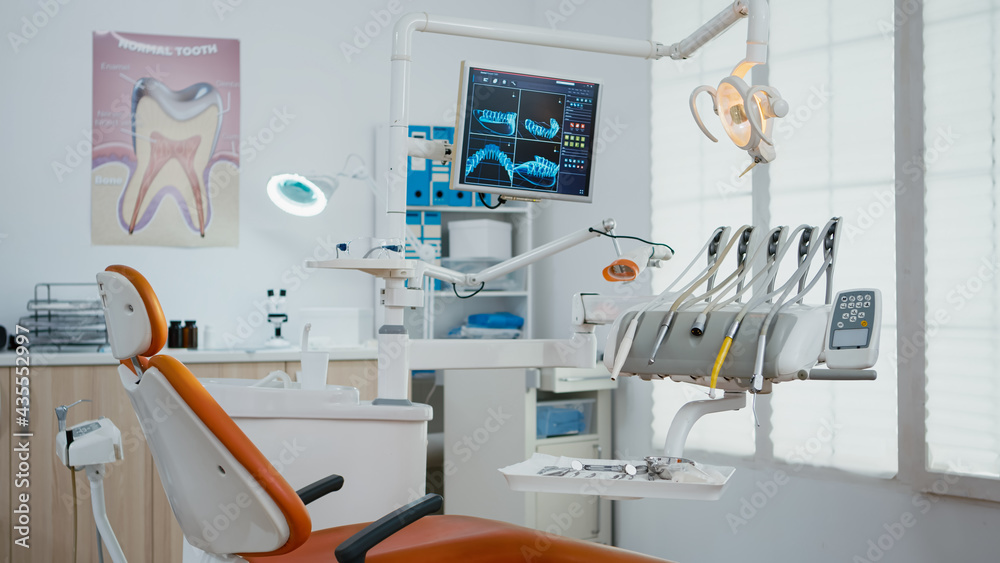 Interior of empty stomatology orthodontist office with nobody in it prepared for tooth surgery. Zoom in shot of teeth radiography on monitor. Orthodontic clinic with professional dentist equipment