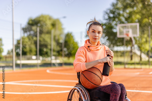 Sporty girl, looking at camera, sitting in a wheelchair, disability.
