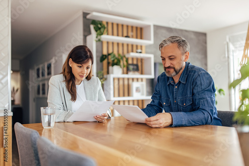 Couple reading an agreement or contract at home.