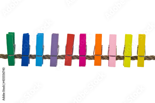 Colored clothespins on a rope isolated on white background.