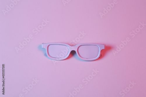 White glasses in pink-blue neon light. Minimalism music concept