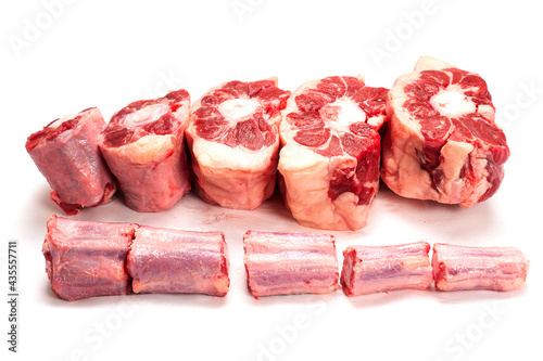 Photos Raw uncooked beef oxtail cut into portions on white isolated background