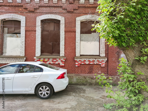 Car on the background of an old building with trees