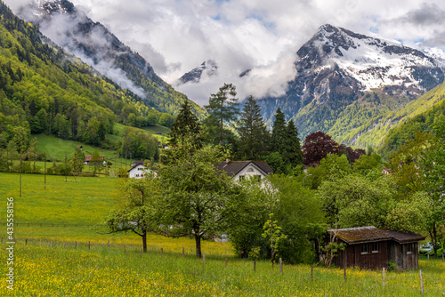 landscape in the mountains of Glarus, Switzerland. View of the valley with the snow peaks in the background