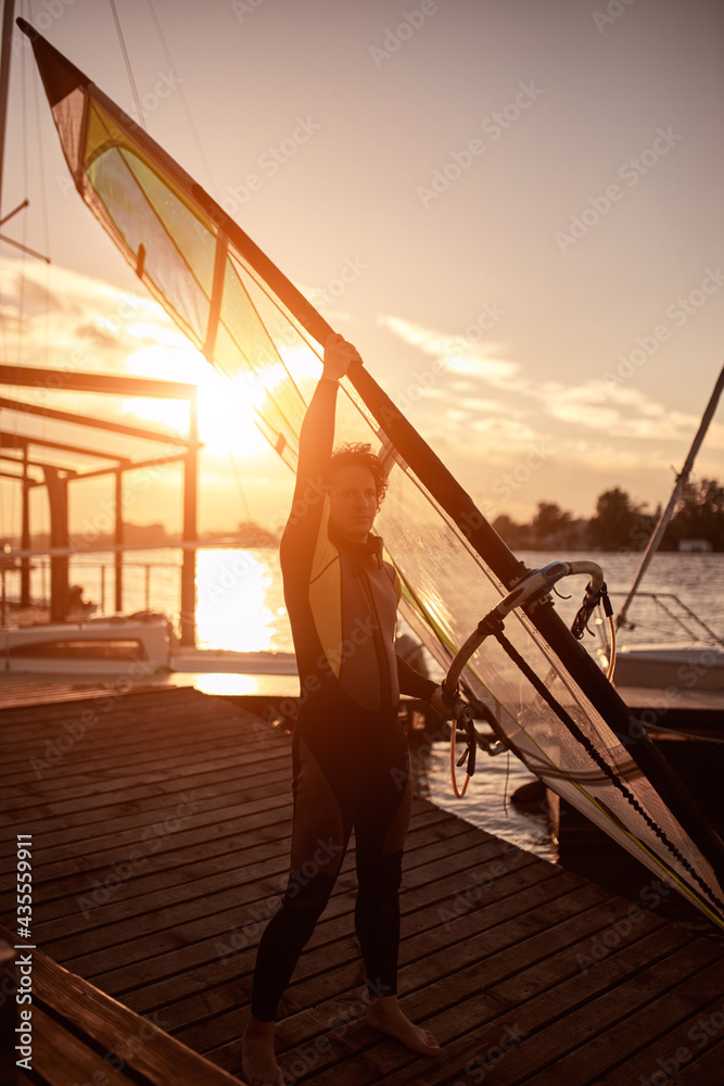 Fototapeta premium Windsurfer surfing on a windy day at the river.