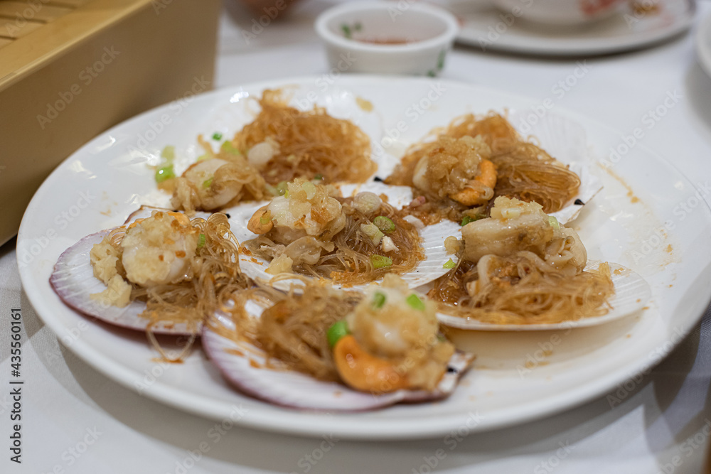 Steamed scallops with vermicelli on the dining table Steamed scallops with vermicelli on the dining table