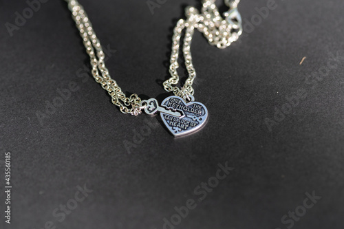 Couple set pendant necklace with a key and a heart for lovers closeup. Selective focus. High quality photo