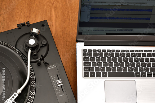 Computer laptop and turntable for digitizing vinyl records. Playing and recording vinyl records on computer software for music collections.