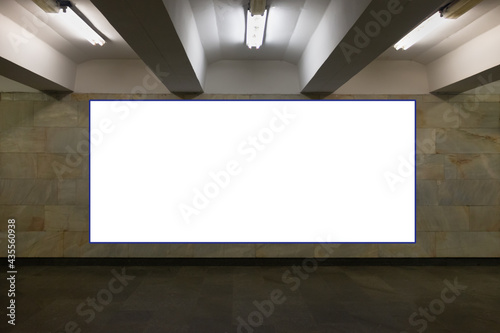 Vertical blank white billboard on a wall at metro station  Mock up. Poster on the indoor wall In the underground