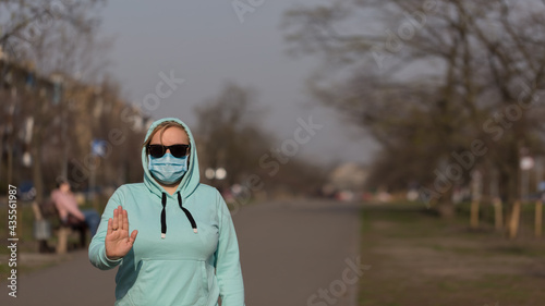 Global call to stay home. Girl wearing protective mask from disease