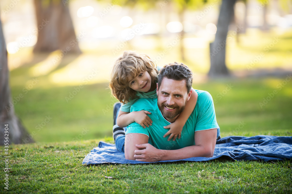 Fototapeta premium Happy father and little boy son walking in summer park.