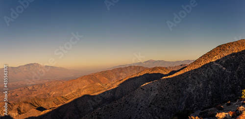 View of bare desert hills and valley at morning sun and dust in joshua tree national park in america